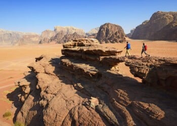 Couple hiking at Rock Arch, Al Borg Alsagheer, Wadi Rum, Jordan, Middle East, Orient
- Model Released -